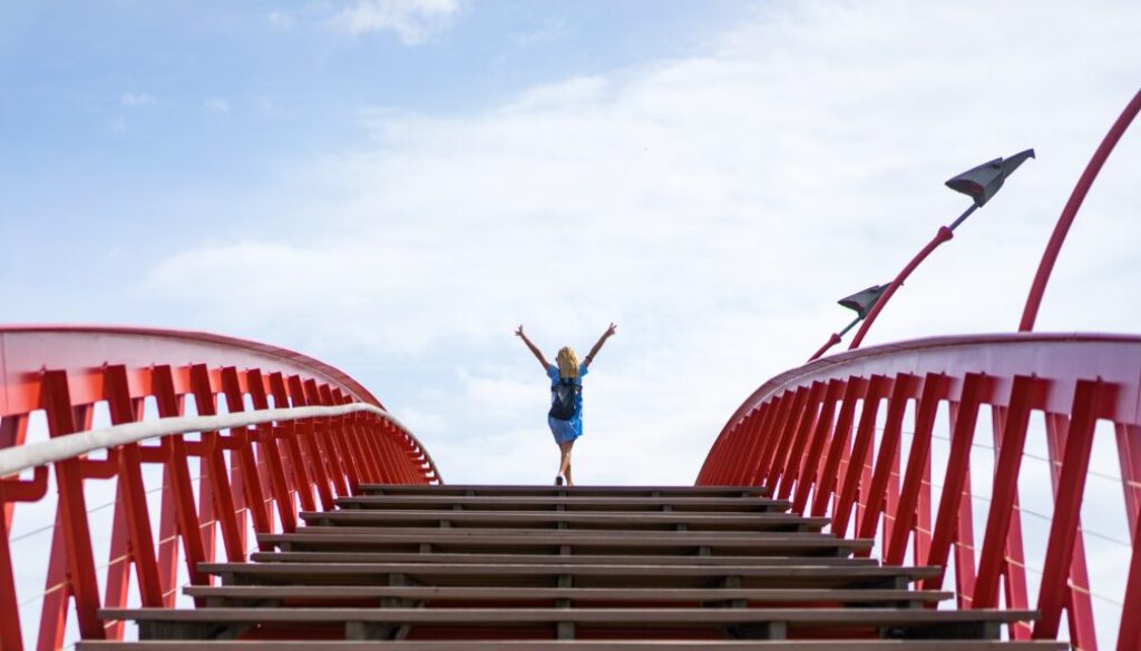 beautiful girl in a blue dress posing on the bridge